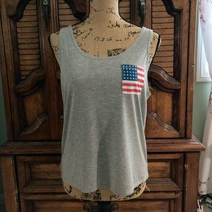 Woman’s gray tank with American flag on pocket, size medium.